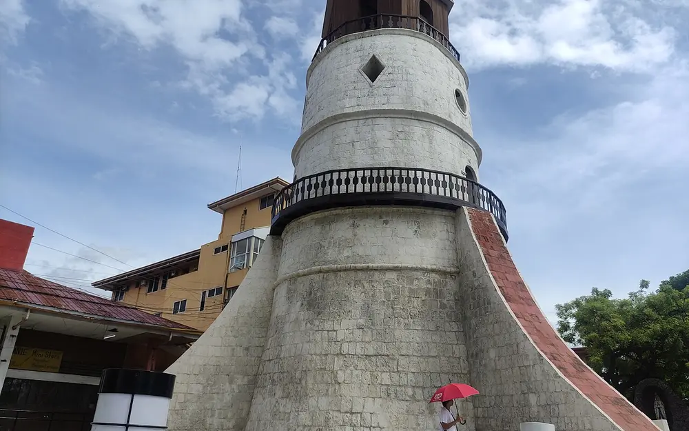 Historic stone Campanario bell tower beside Dumaguete Cathedral
