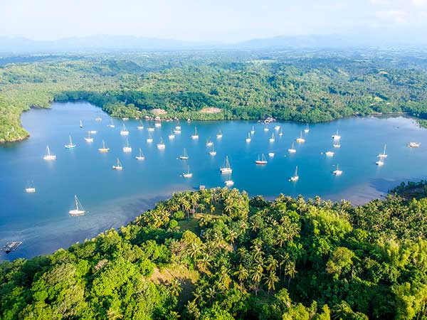 Sailboats anchored in sheltered Tambobo Bay in Siaton